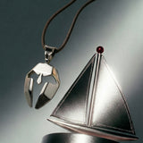 Silver spartan mask pendant with a sailboat 