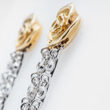 Gold and silver earrings on a white background close up 