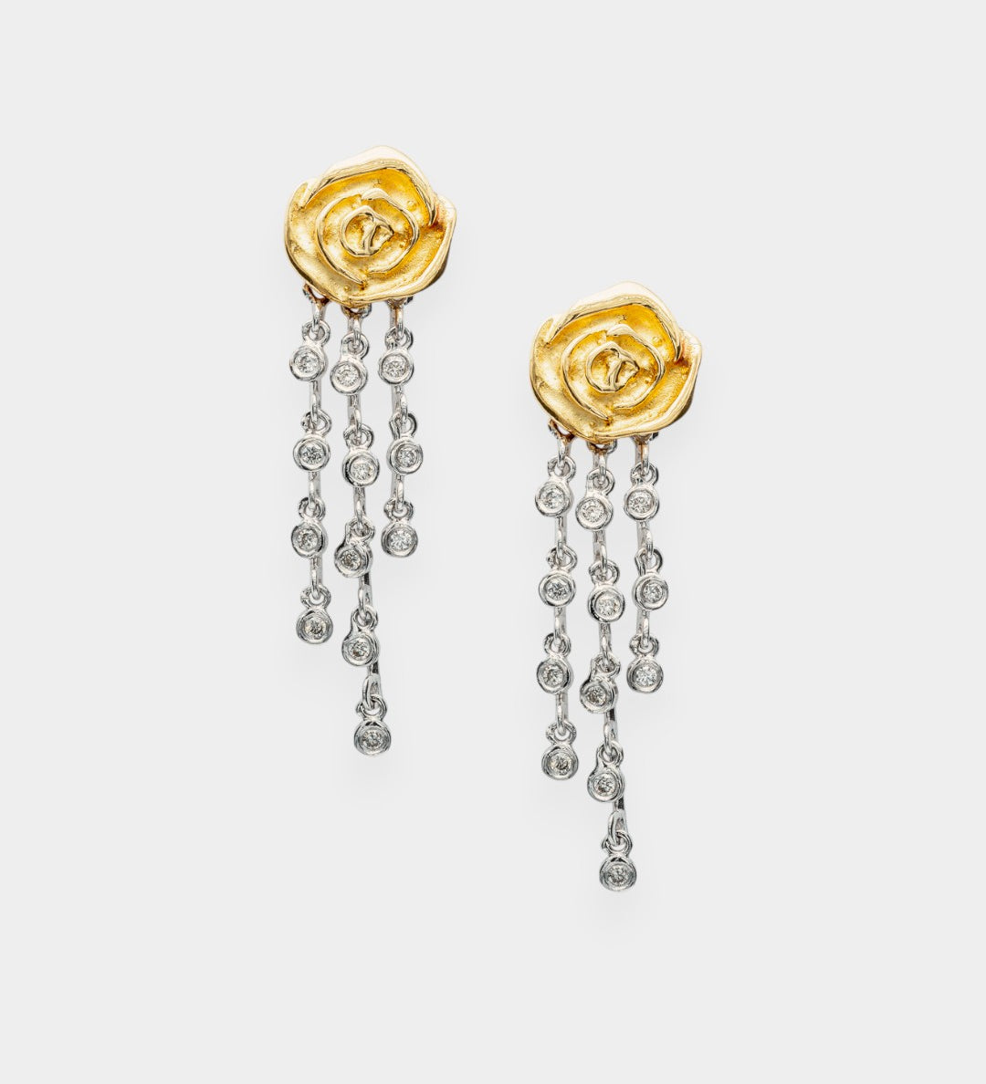 Gold rose-shaped earrings with diamond-like stones on a white background