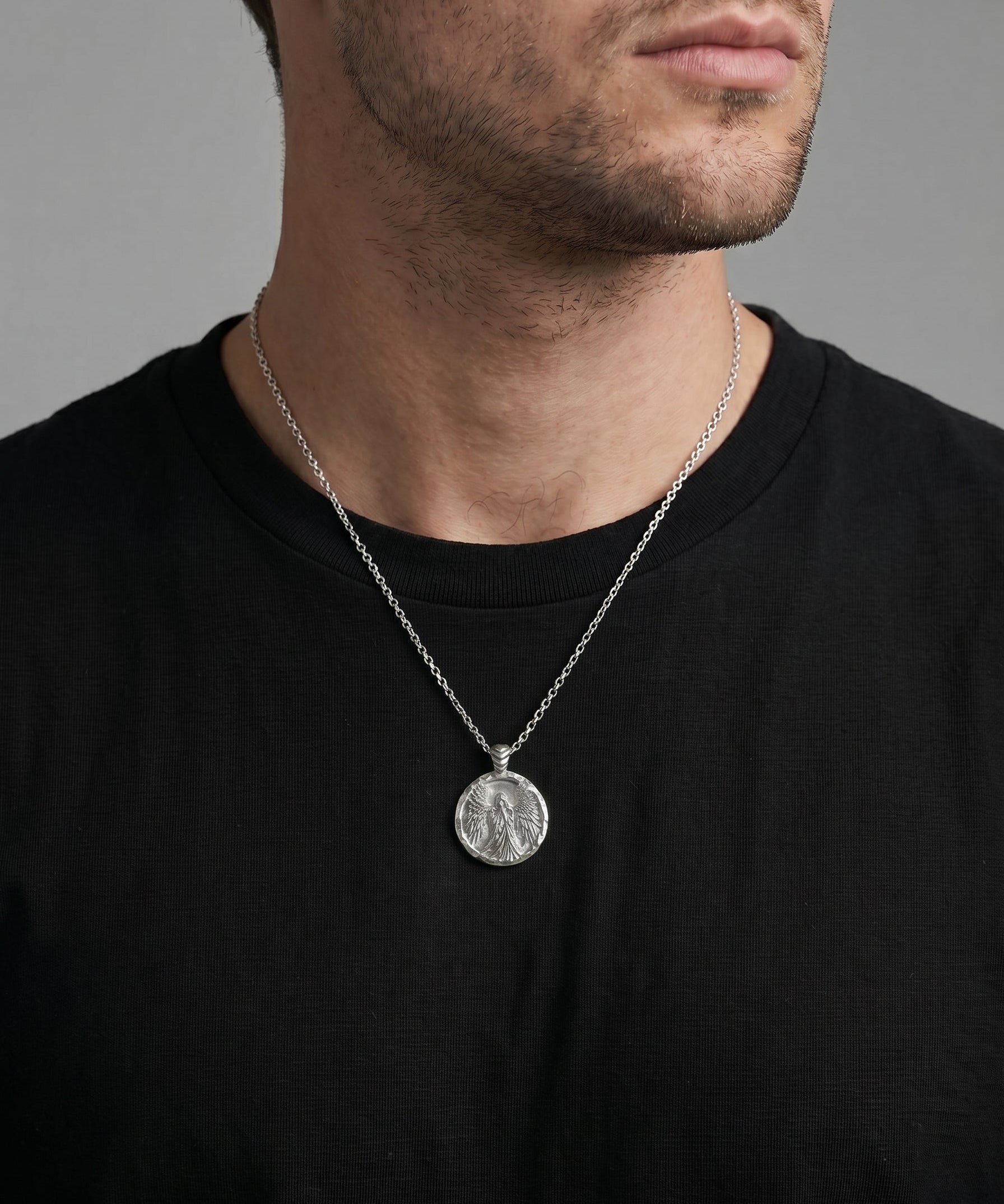 Coin necklace with angel image worn by a man model 