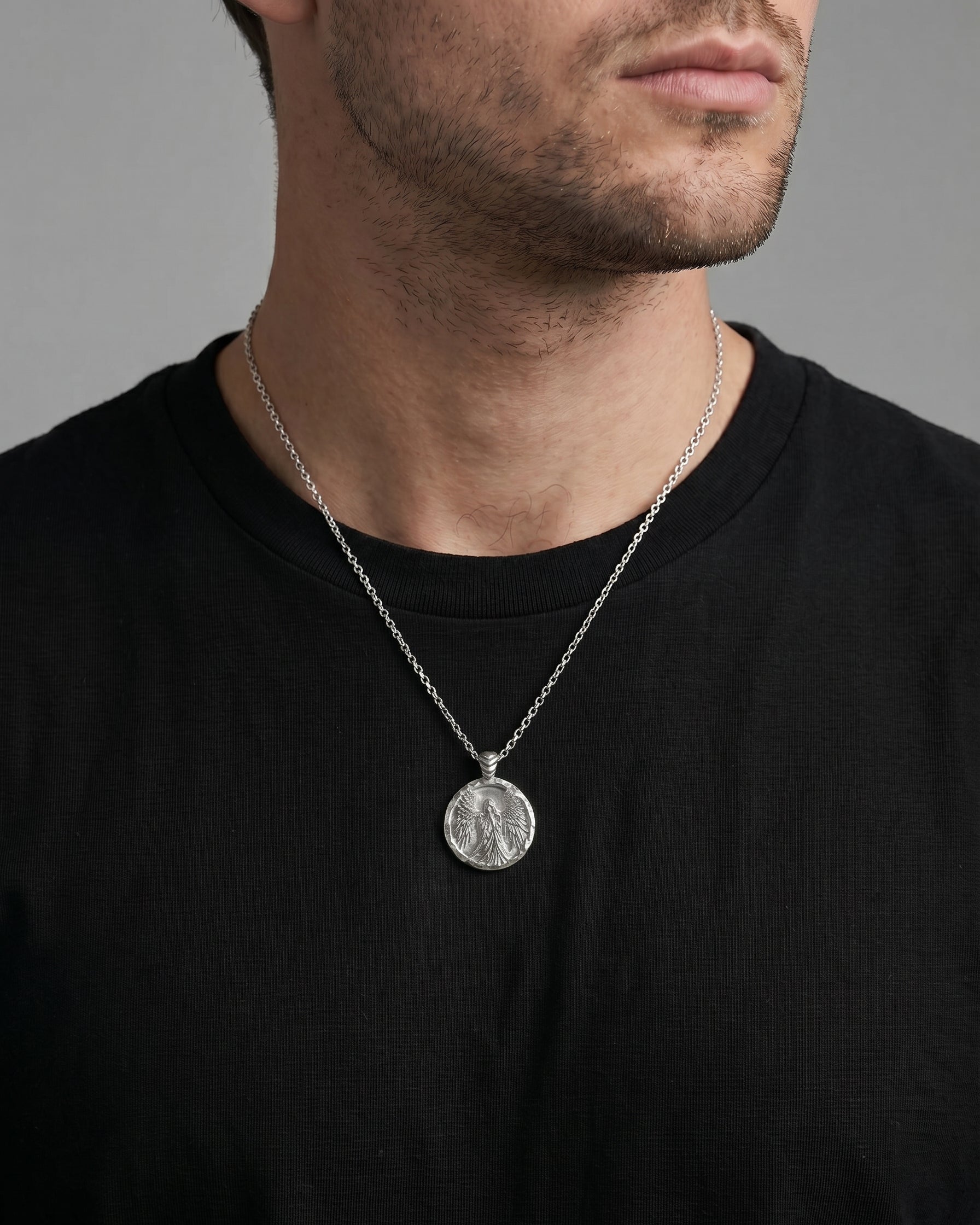 Coin necklace with angel image worn by a man model 