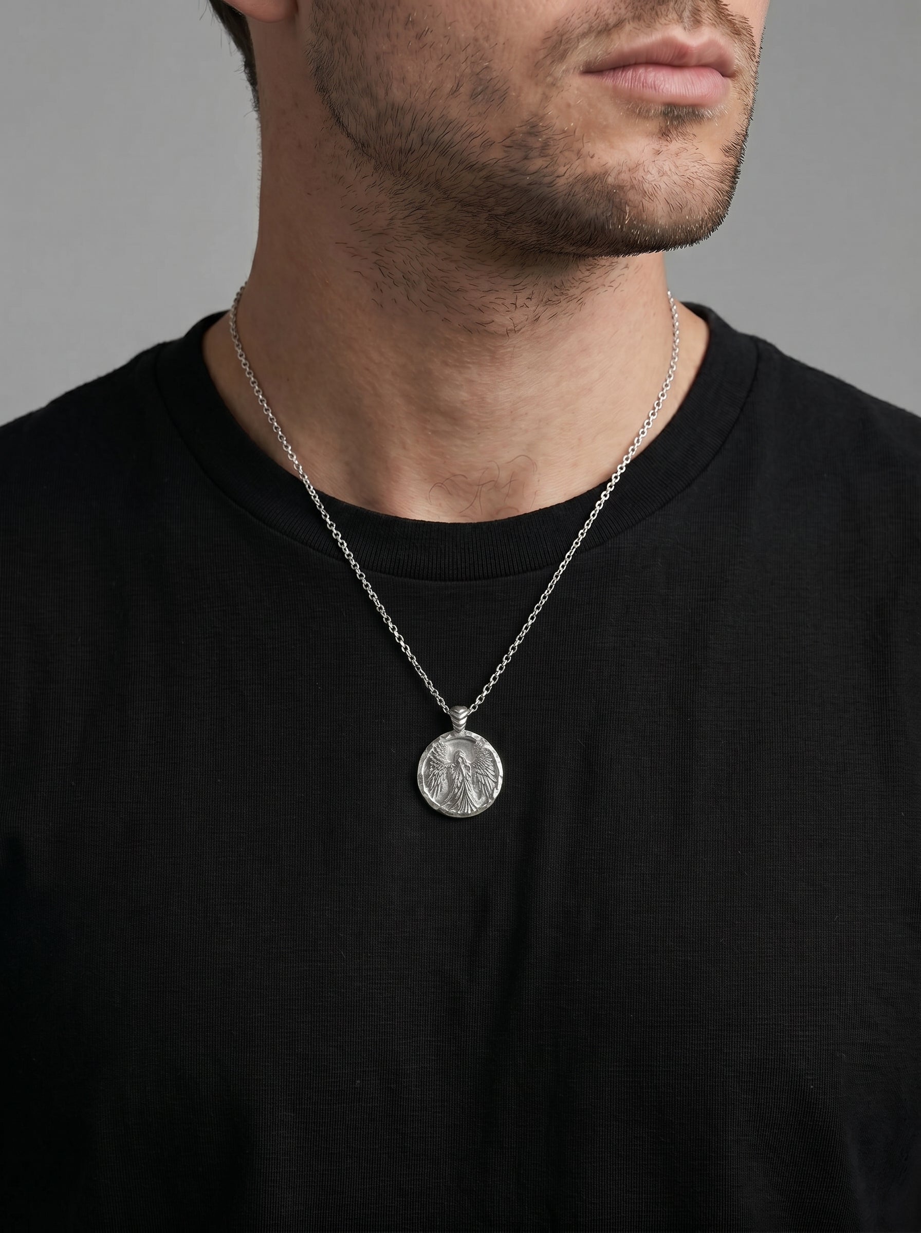 Coin necklace with angel image worn by a man model 