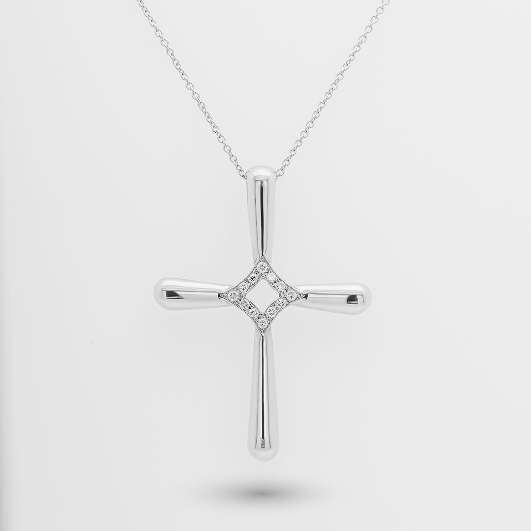 White gold cross pendant necklace on a light gray background