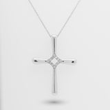 White gold cross pendant necklace on a light gray background