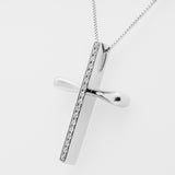 White gold cross pendant necklace on a white background