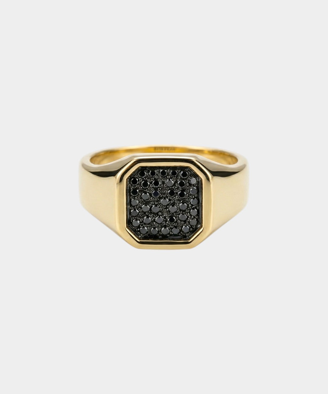 Gold ring with black diamonds on a white background