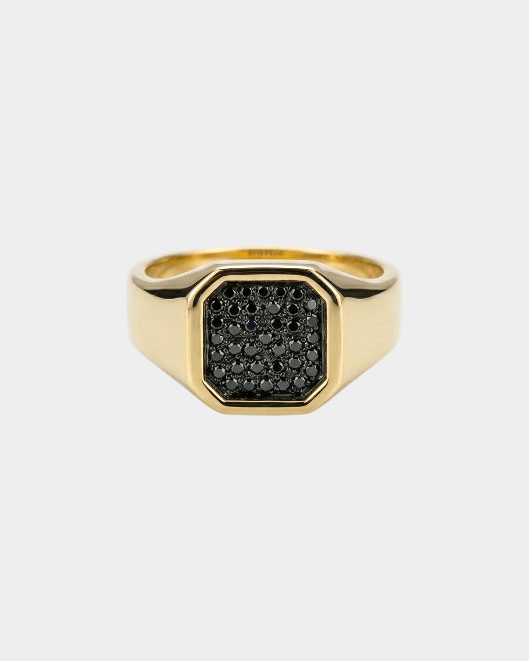 Gold ring with black diamonds on a white background