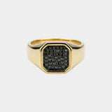 Gold ring with black diamonds on a white background