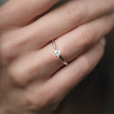 A simple brilliant-cut engagement ring on hand. 