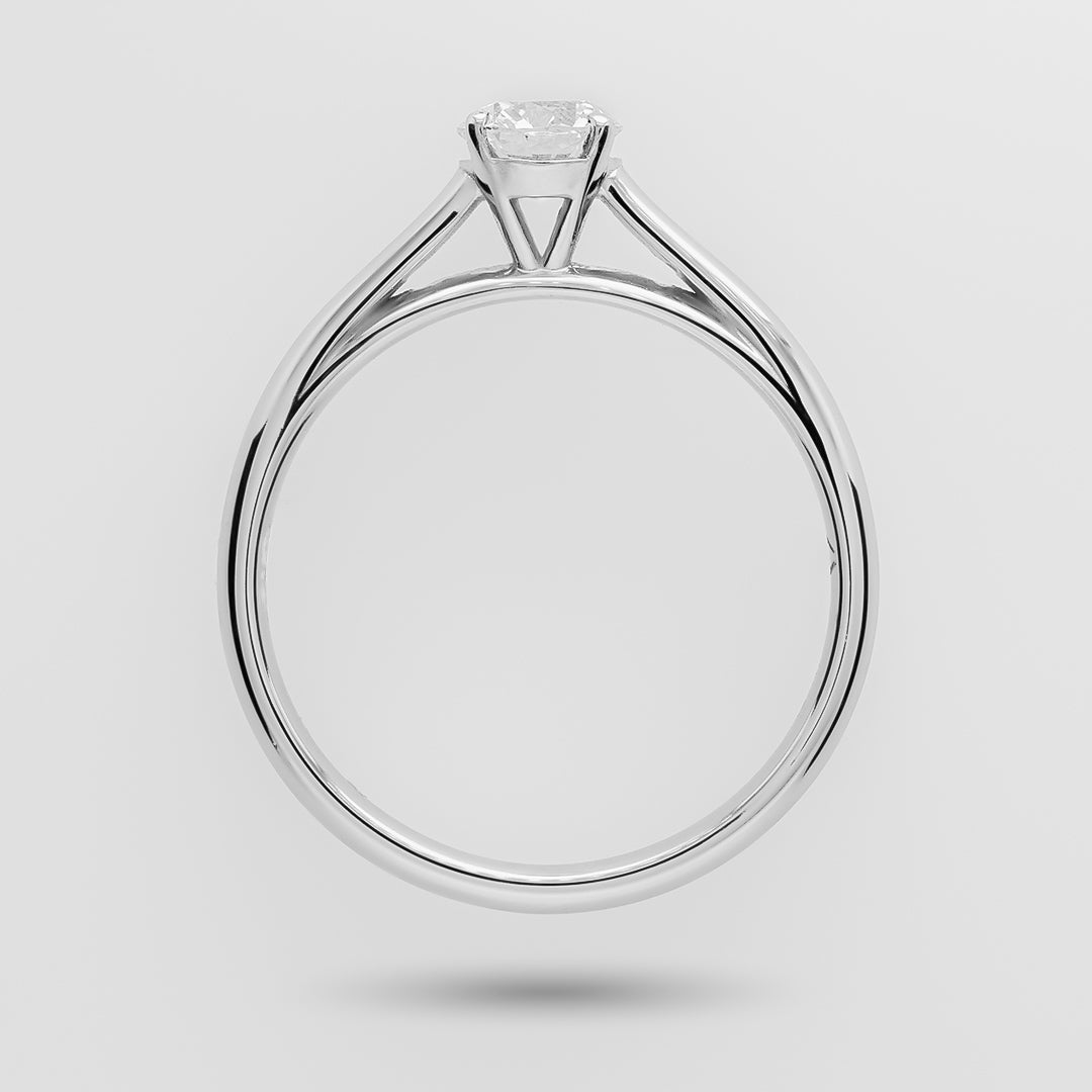 White gold ring with a diamond on a light gray background