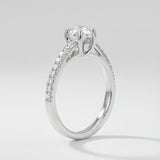 Engagement ring with diamond pave on a light gray background