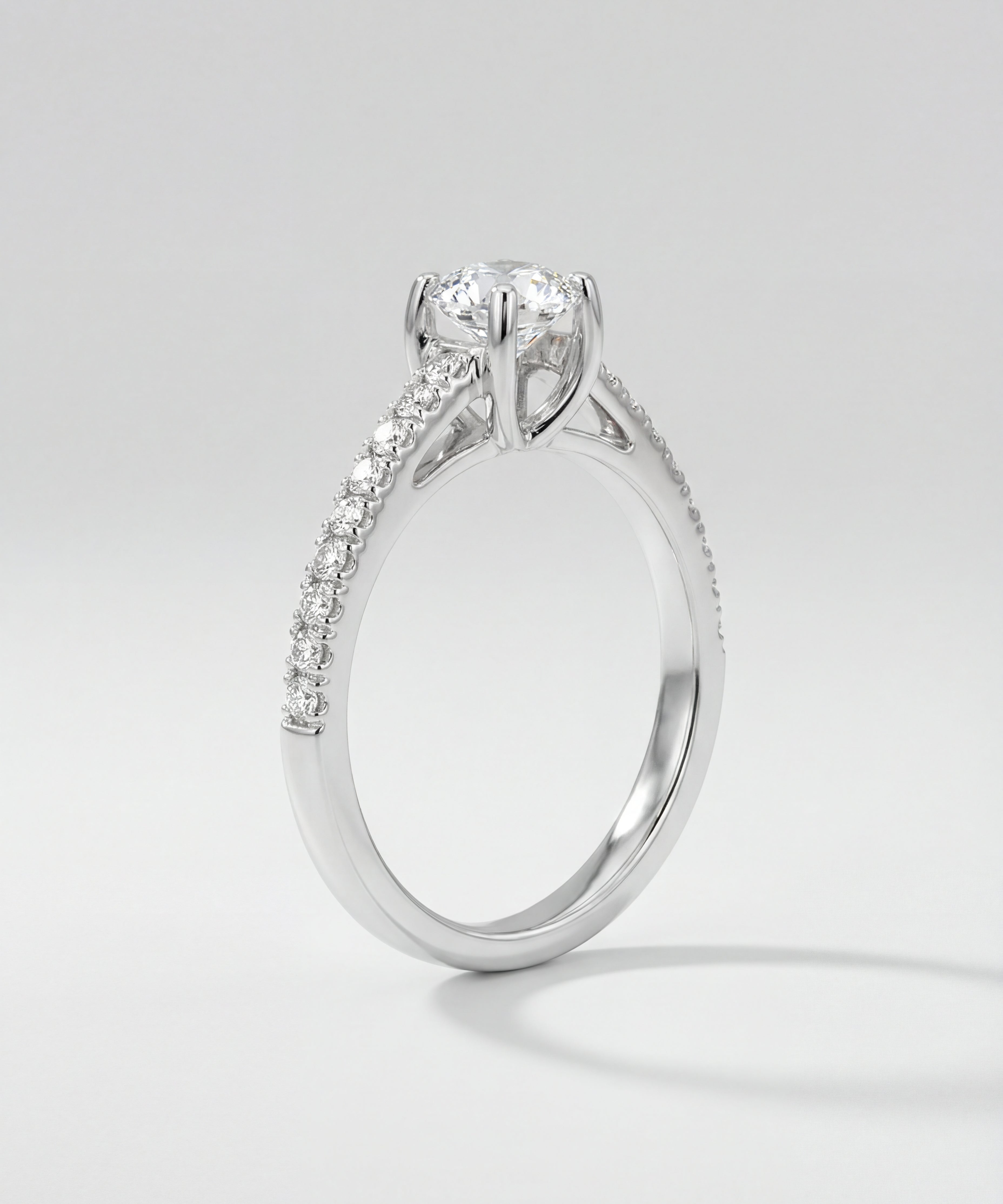 Engagement ring with diamond pave on a light gray background