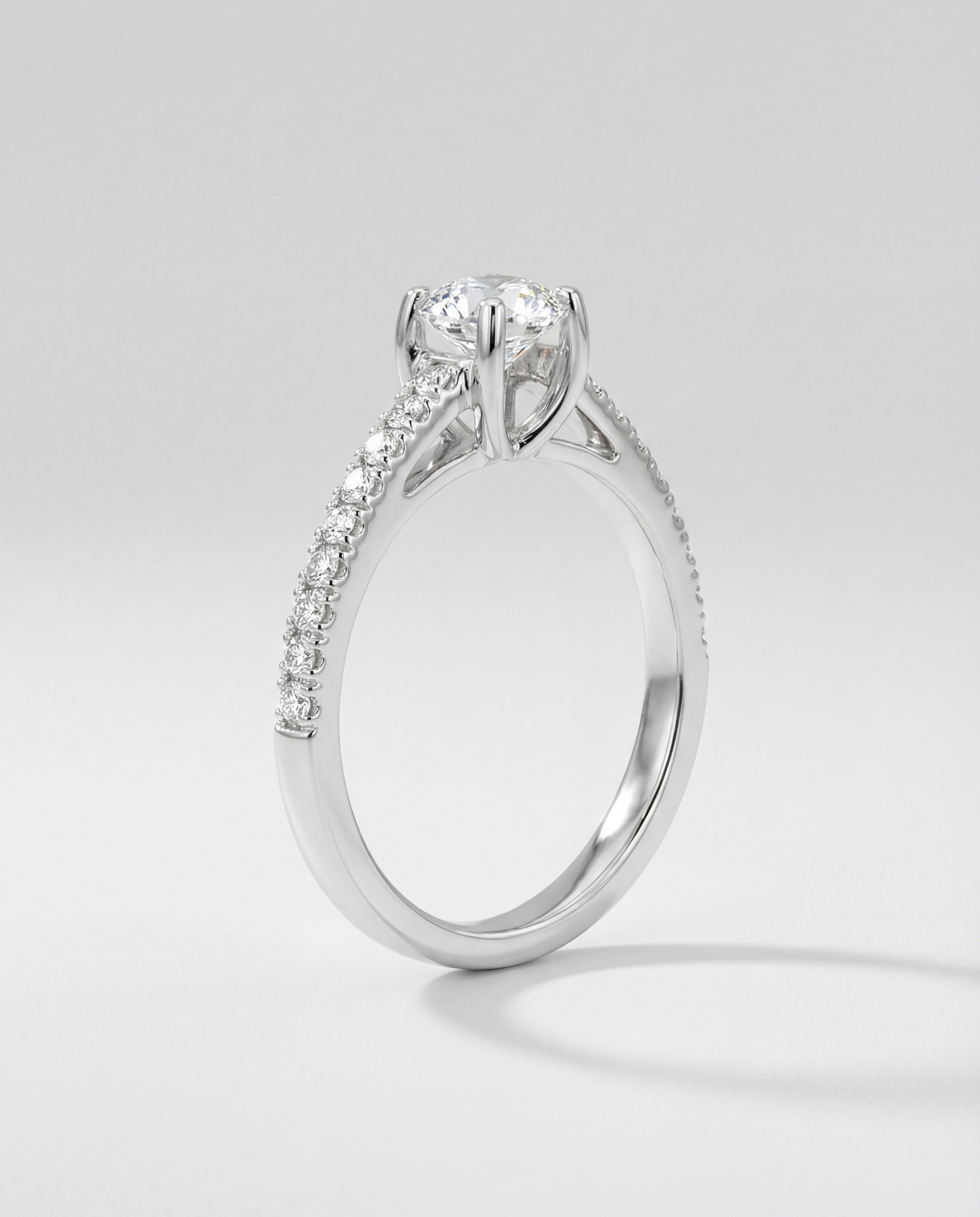 Engagement ring with diamond pave on a light gray background