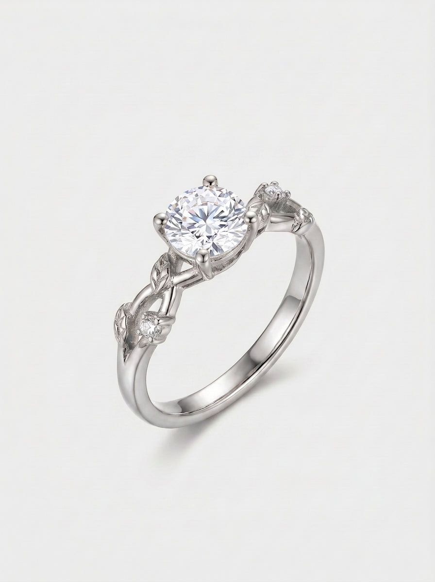 White-gold ring with vine leaf shank with diamonds on a white background