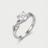 White-gold ring with vine leaf shank with diamonds on a white background