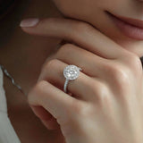 Close-up of a hand wearing a diamond ring with a soft focus background