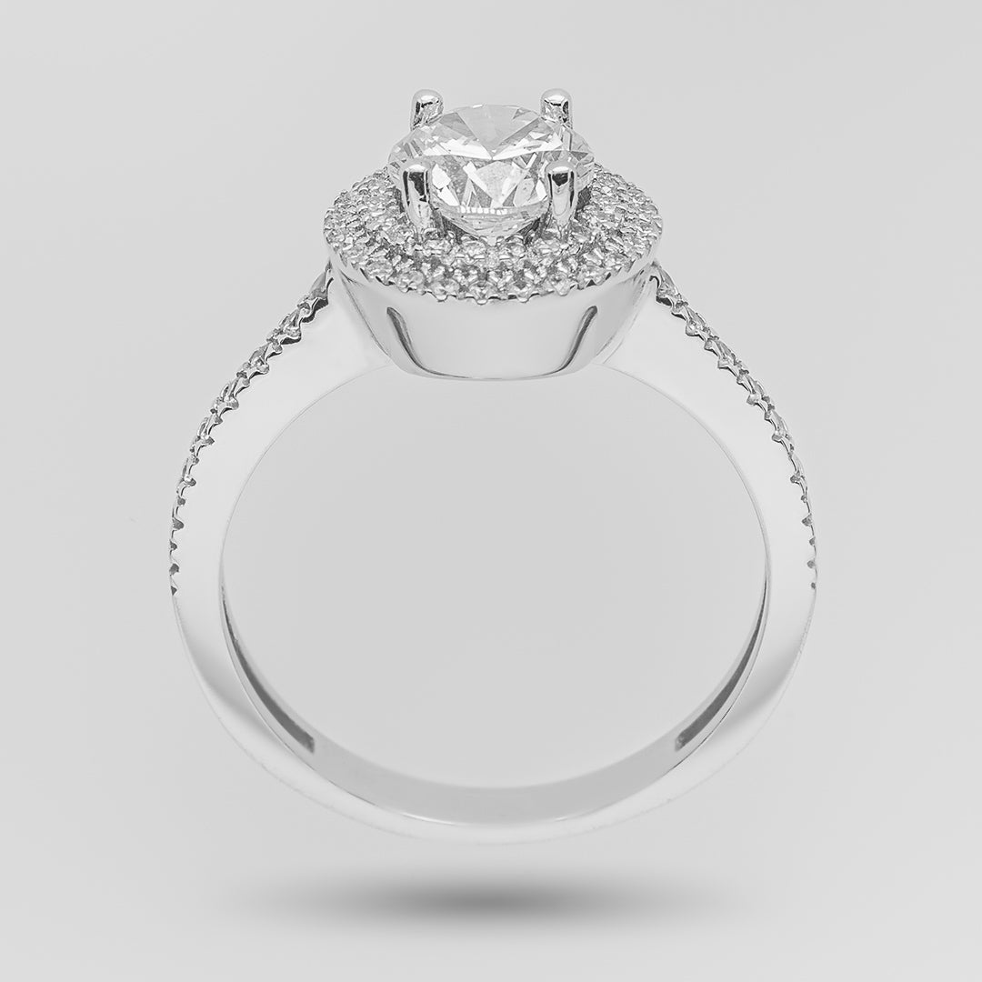 White gold engagement ring with a brilliant-cut diamond and double halo on a light gray background