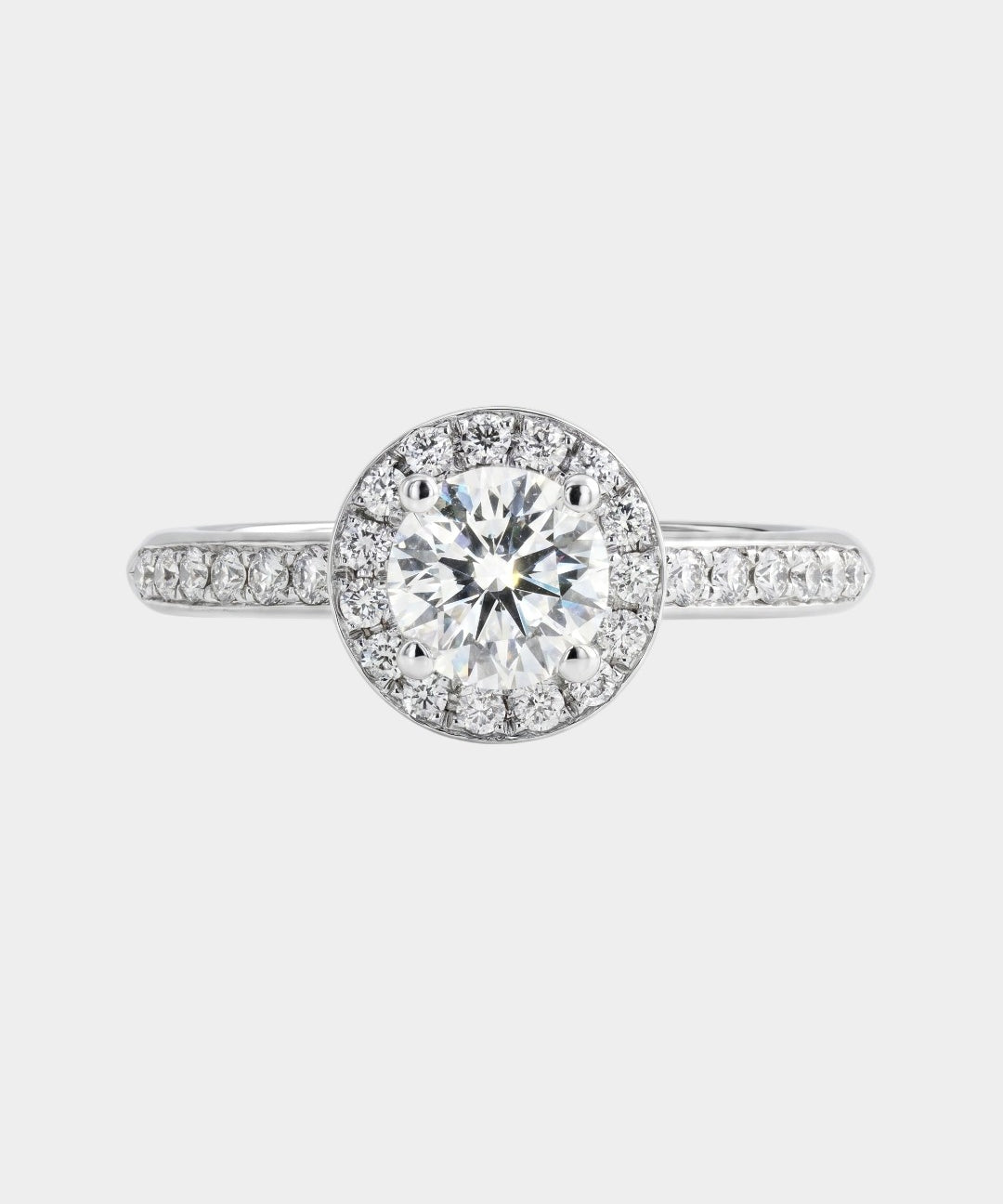 Diamond ring with a clear gemstone on a light gray background