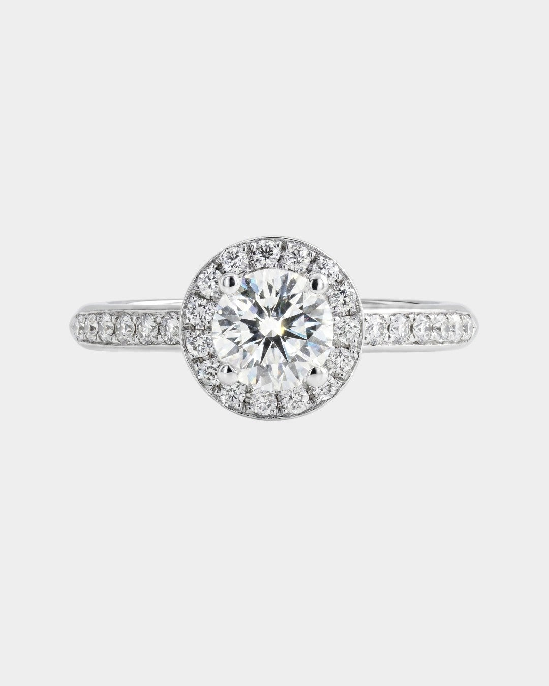 Diamond ring with a clear gemstone on a light gray background