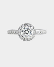 Diamond ring with a clear gemstone on a light gray background