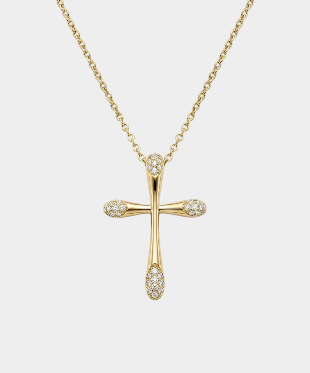 Gold cross necklace with diamonds on a white background