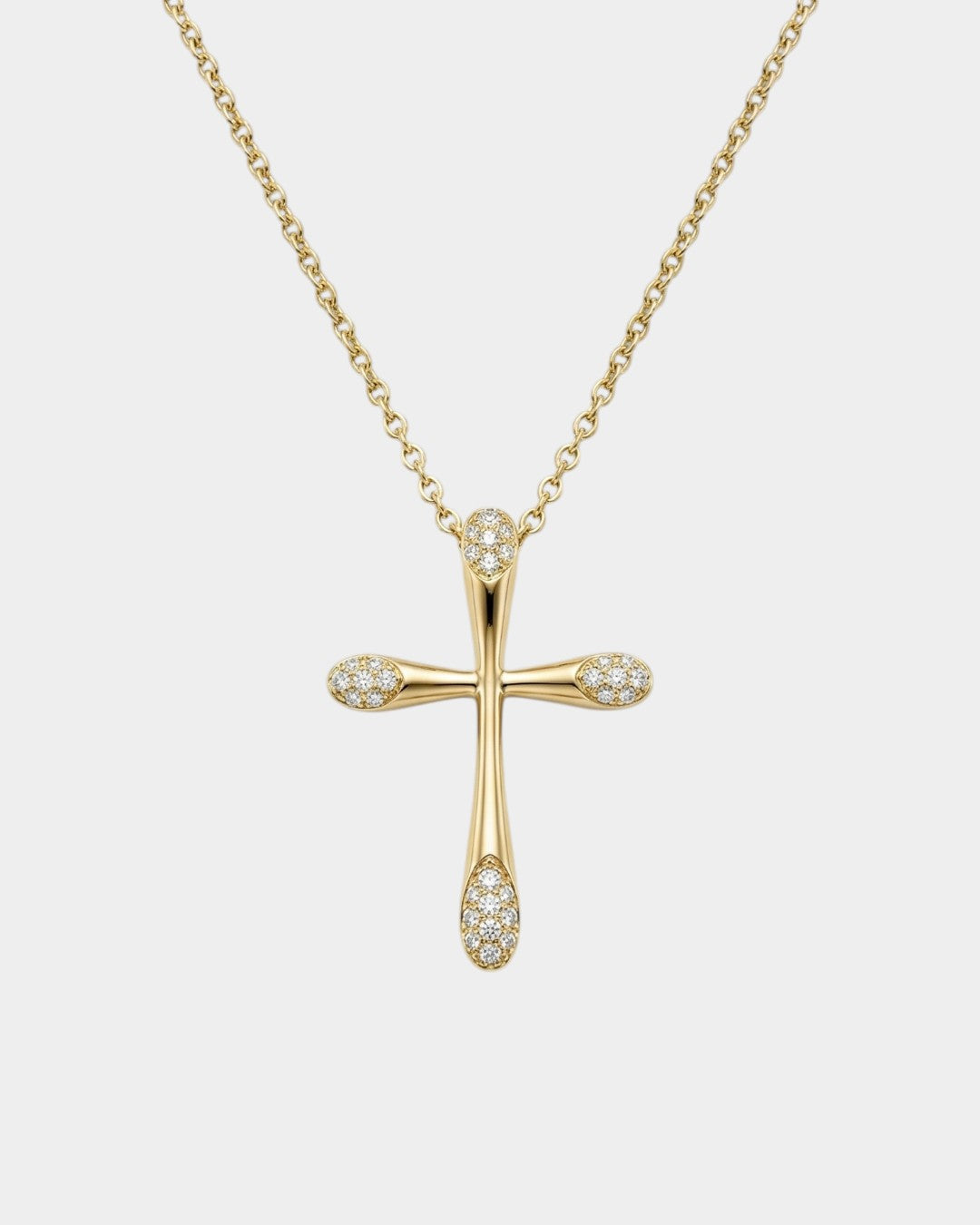 Gold cross necklace with diamonds on a white background