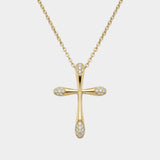 Gold cross necklace with diamonds on a white background