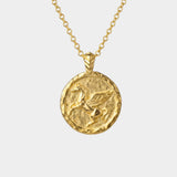 Gold necklace with a round pendant featuring a pegasus design on a white background