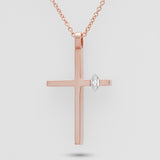 Rose gold cross pendant with a diamond on a light gray background