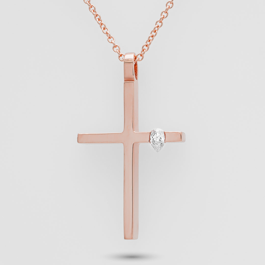 Rose gold cross necklace with a diamond on a light gray background