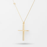 Gold cross necklace on a white background