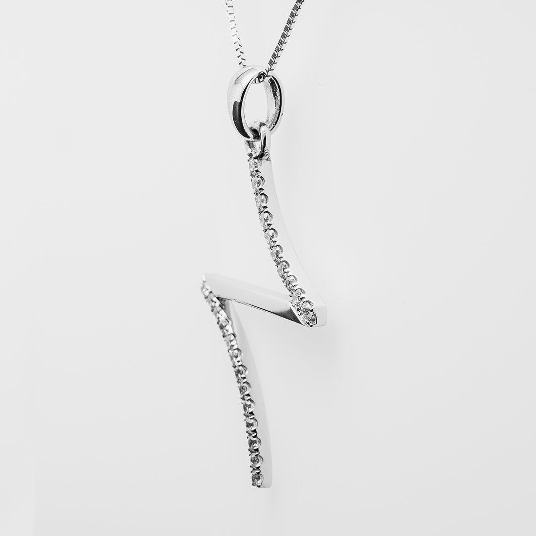 White gold necklace with a cross-like pendant on a white background