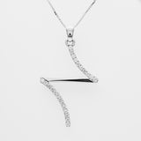 Diamond necklace with a wavy design that is like a cross on a white background