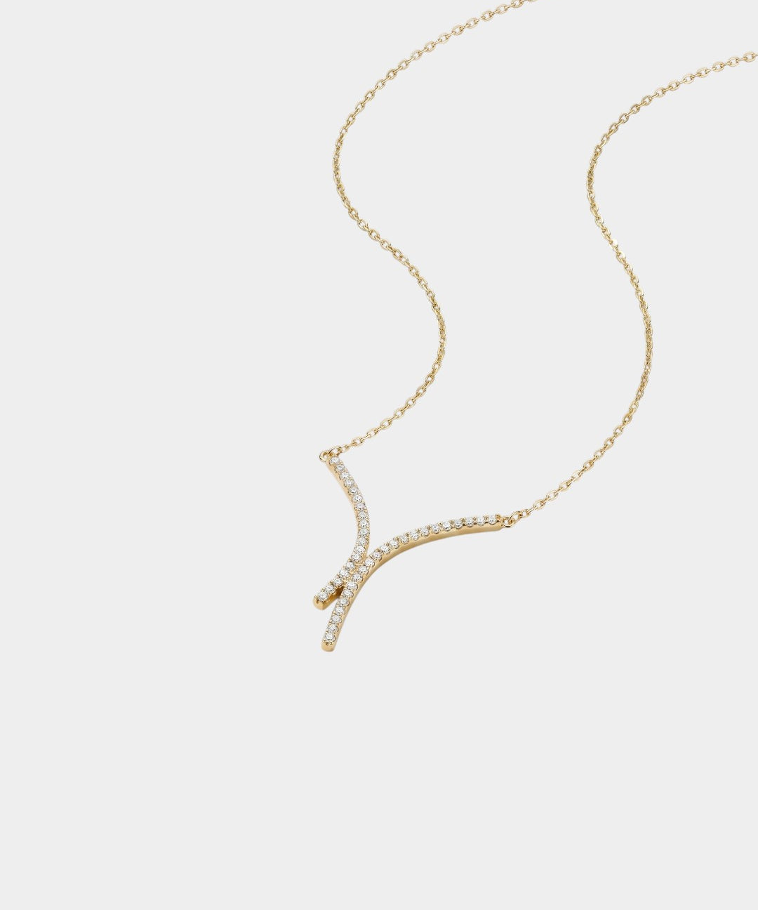 Gold necklace with diamond accents on a white background