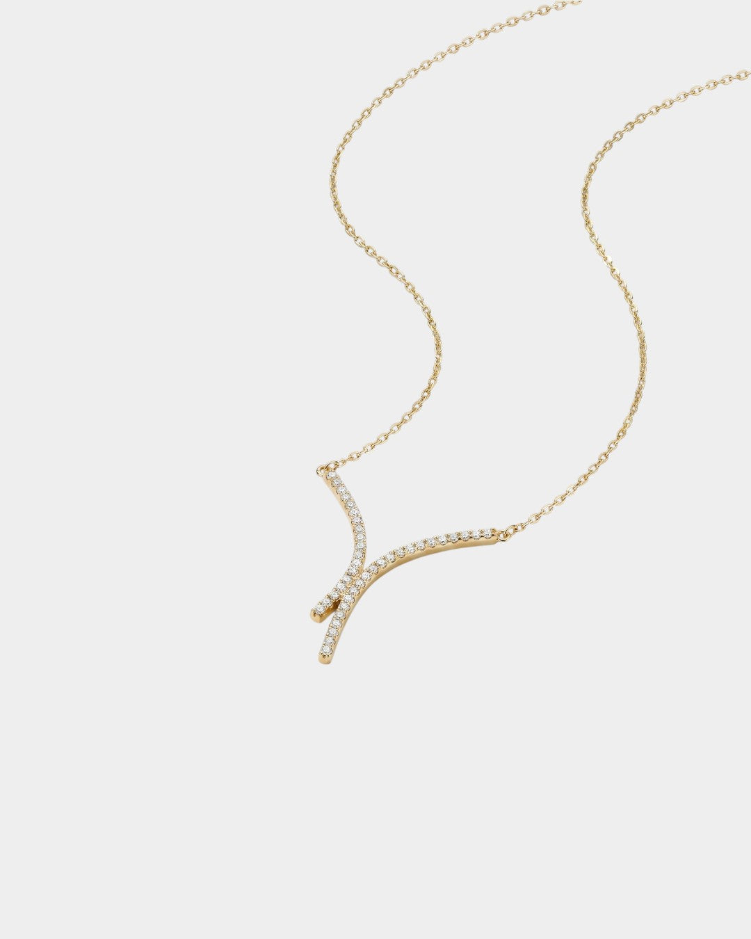 Gold necklace with diamond accents on a white background