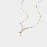 Gold necklace with diamond accents on a white background