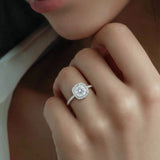 Close-up of the model's hand with a cushion-cut diamond engagement ring