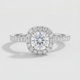 Diamond ring with a halo on a light gray background