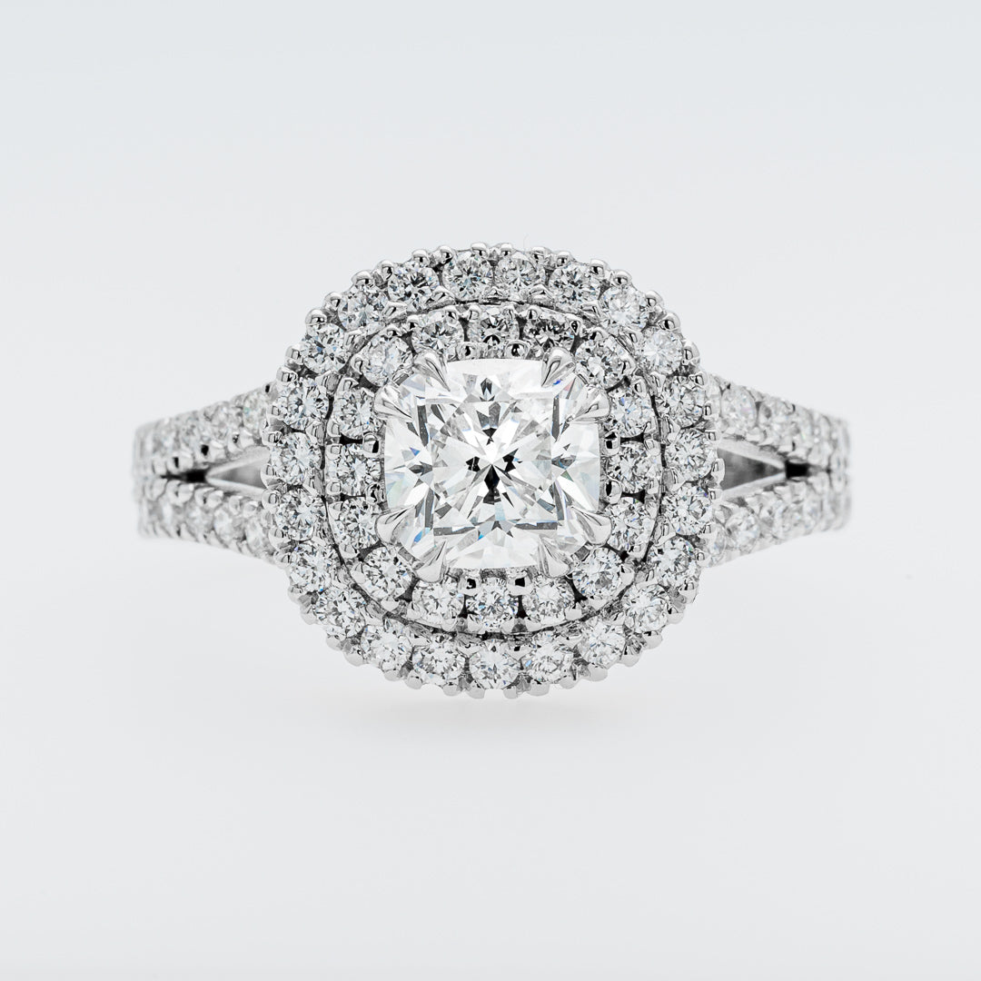 Diamond ring with a halo on a light gray background