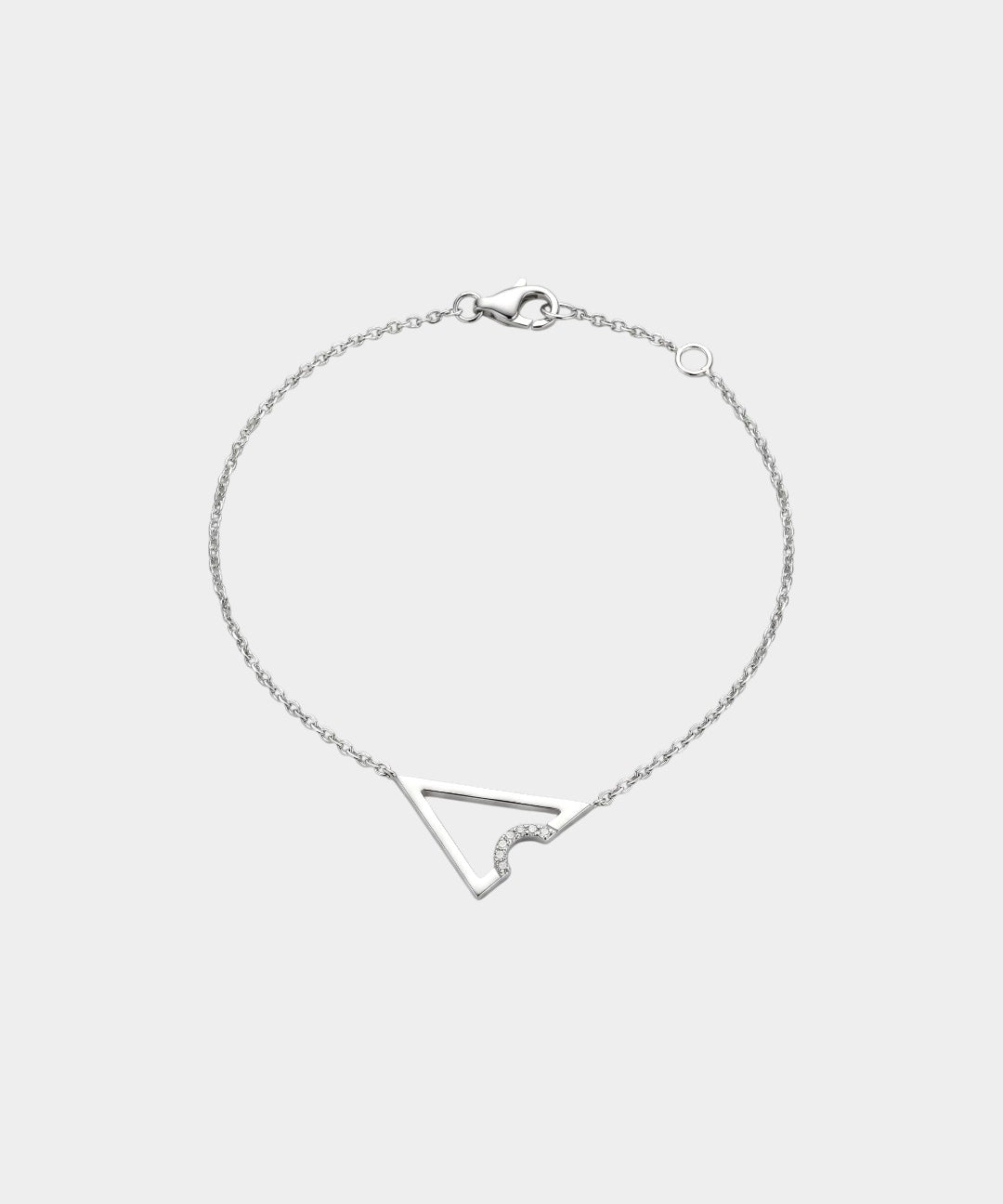 White gold necklace with triangle or delta shape on a light gray background