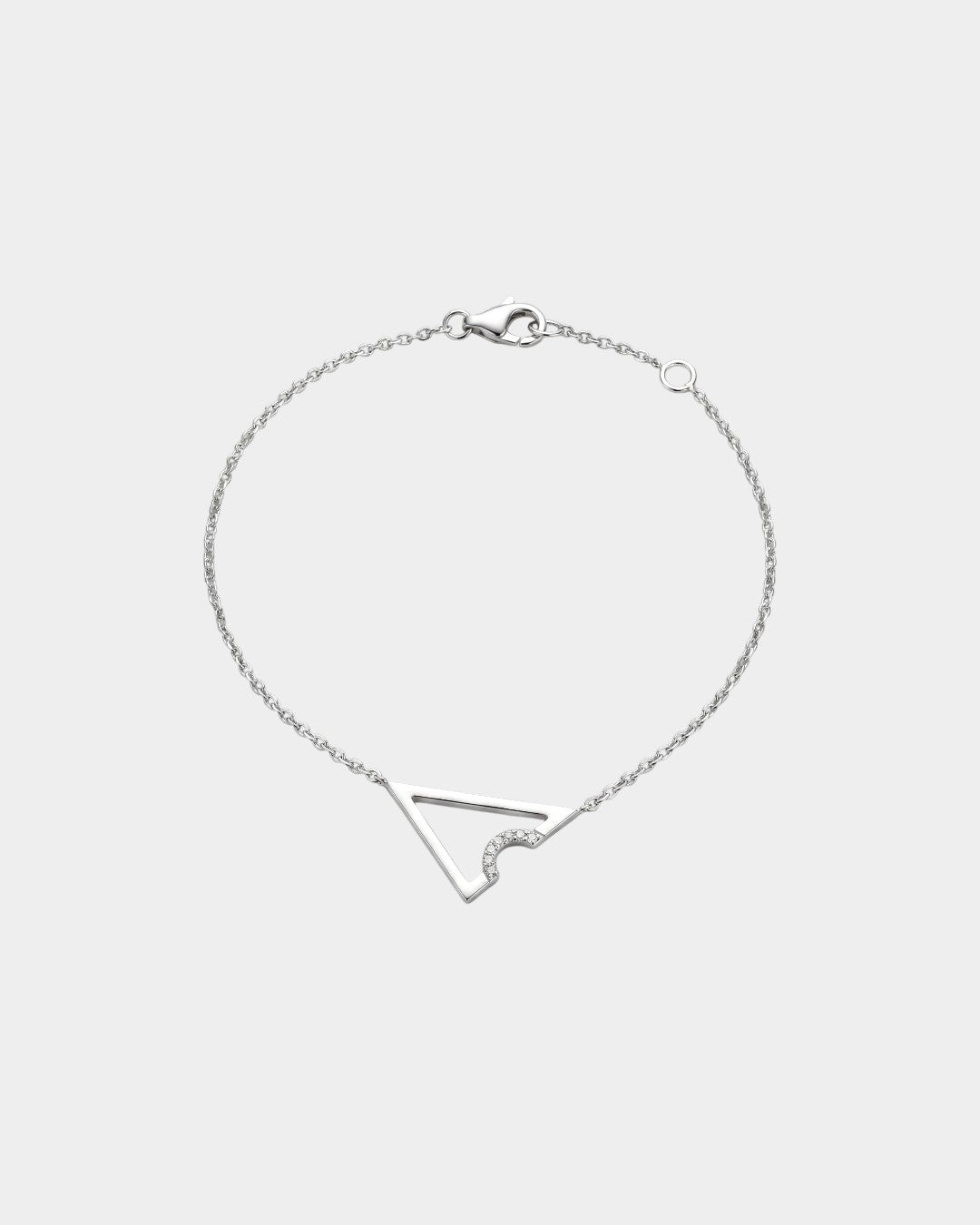 White gold necklace with triangle or delta shape on a light gray background