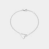 White gold necklace with triangle or delta shape on a light gray background