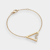 Gold bracelet with a triangle design on a white background