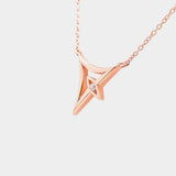 Rose gold necklace with a geometric pendant on a white background