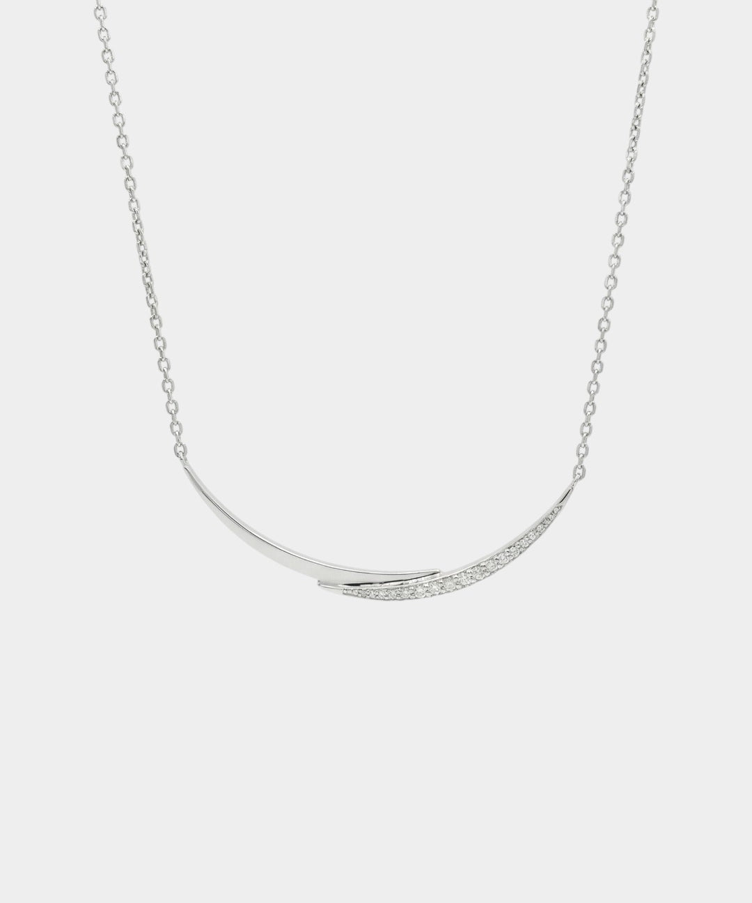 white gold with diamonds necklace with a curved pendant on a light gray background