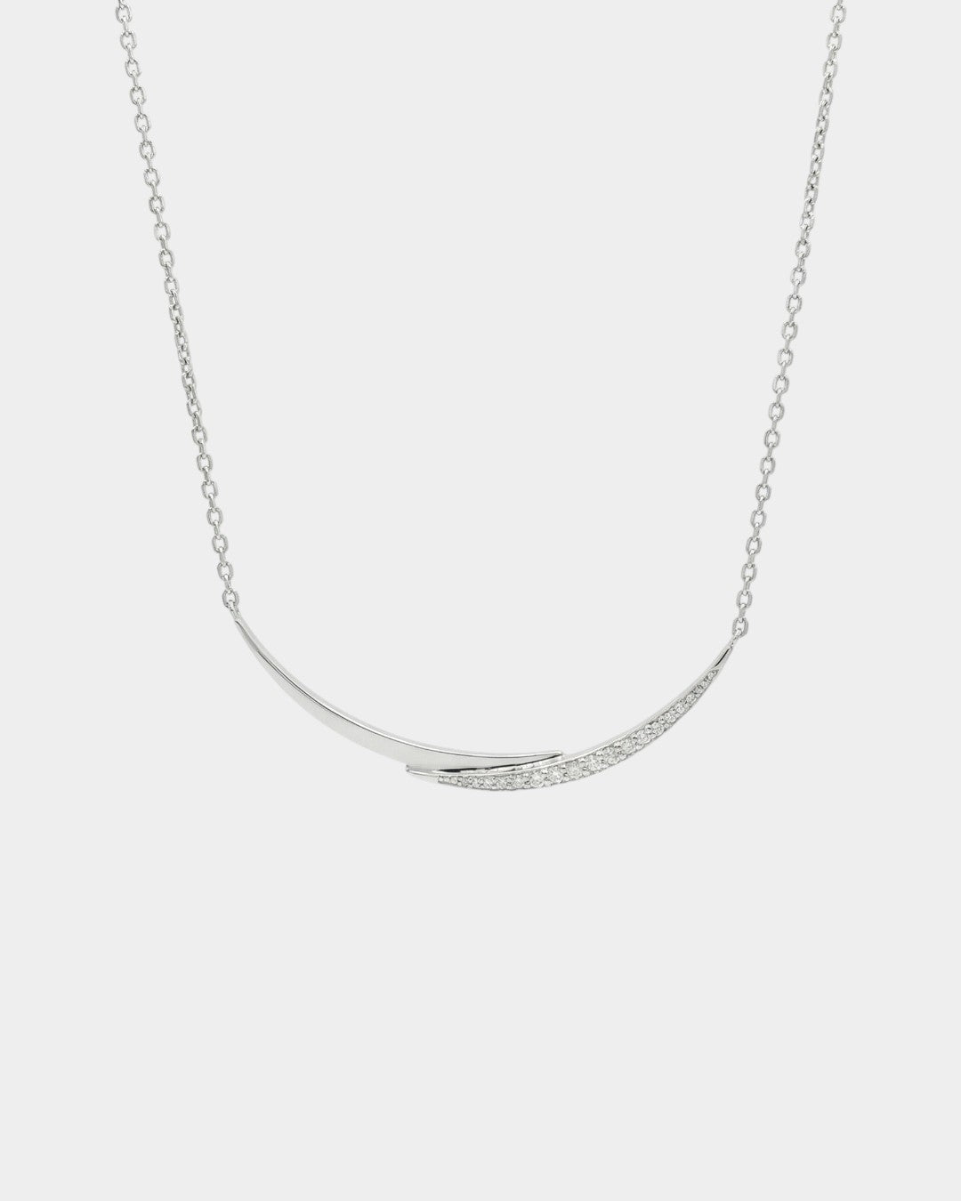 white gold with diamonds necklace with a curved pendant on a light gray background