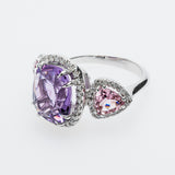 White gold ring with purple and pink gemstones on a white background