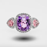 Ring with purple gemstone and pink stones on a light gray background