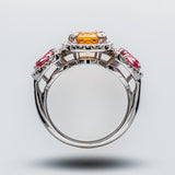 Elegant ring with colorful gemstones on a light gray background