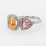 A ring with colorful tourmaline and citrine gemstones on a white background